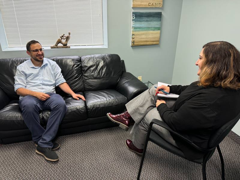 A therapist and a client talking in a bright Thornhill office